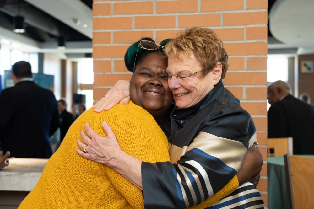 Lynn Blue hugging a guest at the Lynn M. Blue Connection Naming Ceremony